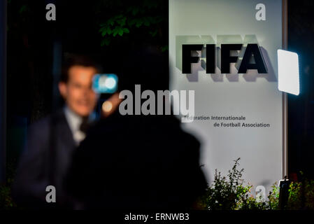 A TV team is reporting from the entrance to the FIFA headquarters in Zurich, Switzerland, on the night Sepp Blatter announced his resignation as FIFA president. Stock Photo