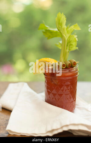 Bloody Mary vodka cocktail made at home sitting on counter by window Stock Photo