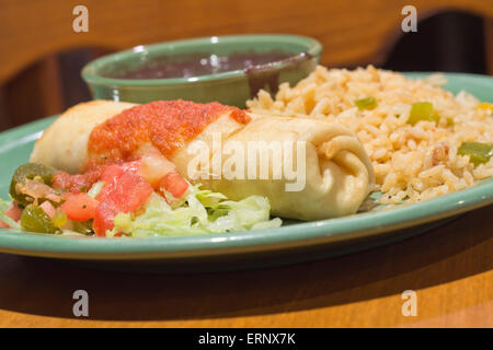 Chimichanga deep fried burrito with spanish rice and black beans Stock Photo