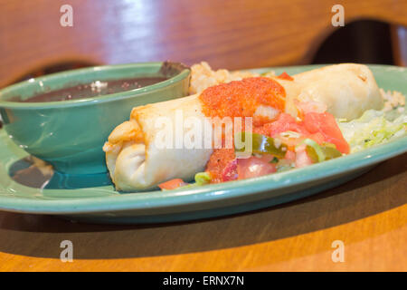 Chimichanga deep fried burrito with spanish rice and black beans Stock Photo