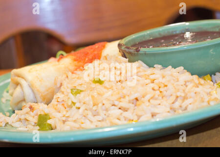 Chimichanga deep fried burrito with spanish rice and black beans Stock Photo