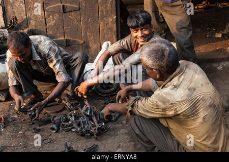 Indian workings sitting together in a market in Mumbai, India Stock Photo