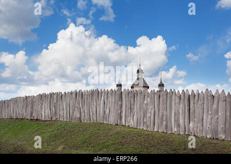 Old wooden fence against blue sky with clouds. Background for design Stock Photo