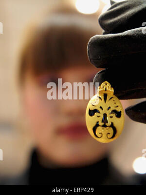 Beijing, China. 18th Jan, 2011. File photo taken on Jan. 18, 2011 shows a gold jewelry designed as a Peking Opera mask in Liaocheng, east China's Shandong Province. Peking Opera masks have gradually become a fashionable element in Chinese daily life. © Zhang Xianju/Xinhua/Alamy Live News Stock Photo