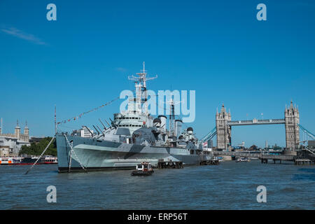 HMS Belfast museum ship moored on River Thames, with Tower Bridge in the background, London UK