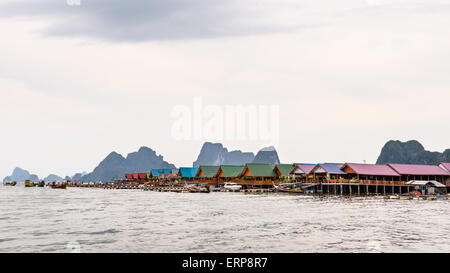 Pier and restaurants floating over the sea at Punyi Island or Koh Panyee during a boat tour in the Ao Phang Nga Bay, Thailand Stock Photo