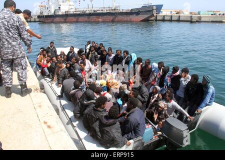 Tripoli, Libya. 06th June, 2015. A batch of illegal immigrants sit on a boat of the Libyan coast guard near Garabulli, Libya on June 6, 2015. The Libyan coast guard intercepted dozens of sub-Saharan nationals trying to stow away to Europe from Libyan coast. Credit:  Xinhua/Alamy Live News Stock Photo