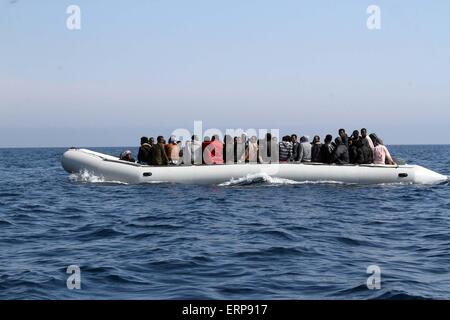 Tripoli, Libya. 06th June, 2015. A batch of illegal immigrants sit on a boat of the Libyan coast guard near Garabulli, Libya on June 6, 2015. The Libyan coast guard intercepted dozens of sub-Saharan nationals trying to stow away to Europe from Libyan coast. Credit:  Xinhua/Alamy Live News Stock Photo