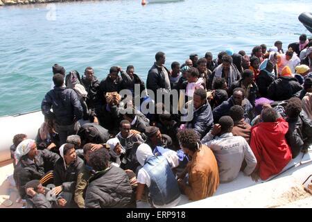 Tripoli, Libya. 06th June, 2015. A batch of illegal immigrants sit on a boat of the Libyan coast guard near Garabulli, Libya on June 6, 2015. The Libyan coast guard intercepted dozens of sub-Saharan nationals trying to stow away to Europe from Libyan coast. Credit:  Xinhua/Alamy Live News Stock Photo