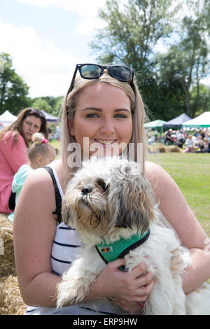 Green St Green, UK. 6th June 2015. A young lady with her dog enjoy the St Christopher's Wild West Fair and food festival. Credit:  Keith Larby/Alamy Live News Stock Photo