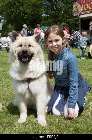 Green St Green, UK. 6th June 2015. A young girl with her dog enjoy the St Christopher's Wild West Fair and food festival. Credit:  Keith Larby/Alamy Live News Stock Photo