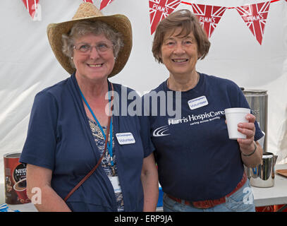 Green St Green, UK. 6th June 2015. Volunteers on the tea stall enjoy the St Christopher's Wild West Fair and food festival. Credit:  Keith Larby/Alamy Live News Stock Photo