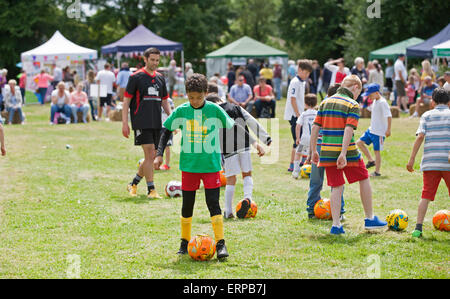 Green St Green, UK. 6th June 2015. Children practice their football skills at the St Christopher's Wild West Fair and food festival. Credit:  Keith Larby/Alamy Live News Stock Photo