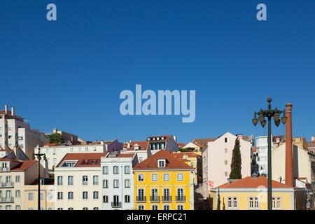 Colourful pombaline style buildings in Lisbon against a bright blue sky in summer Stock Photo