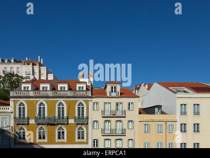 Colourful pombaline style buildings in Lisbon against a bright blue sky in summer Stock Photo