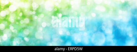 Beautiful defocused highlights in nature create a panorama bokeh composition in green and blue, ideal as a wide format backgroun Stock Photo