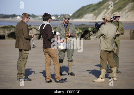 D-Day 71st Anniversary, Normandy France. Services and musical parades are held in Arromanche to mark  the 71st anniversary of the D-Day landings. Veterans and the public enjoy the day at Arromanche, site of the Mulberry Harbour and British D-Day landing sites. Re-enactment groups in period unifroms displayed vintage WW2 vehicles to a back drop of 1940's era music. Stock Photo