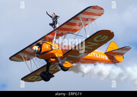Boeing Stearman of the Breitling Wingwalkers team displaying at Throckmorton Airshow 2015, Worcestershire, UK. Stock Photo