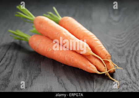 fresh carrots on old oak table Stock Photo