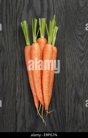 fresh carrots on old oak table top view Stock Photo