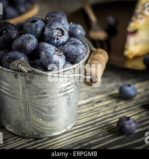 Fresh blueberries and blueberry cake on wooden table Stock Photo