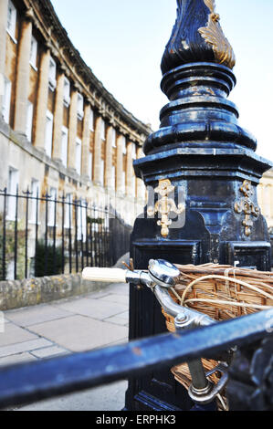 The front basket of a bicycle leaning against a lamp post on the Royal Crescent, a Georgian street in Bath Somerset. Stock Photo