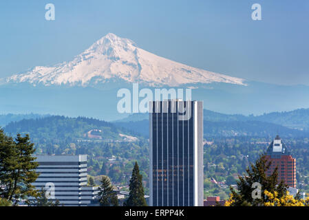 Skyscrapers in downtown Portland, Oregon with Mount Hood rising above them Stock Photo