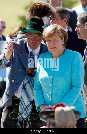German Chancellor Angela Merkel talks to man dressed in traditional Bavarian clothes prior to a meeting with U.S. President Barack Obama in the village of Kruen, southern Germany, Sunday, June 7, 2015 prior to the G-7 summit in Schloss Elmau hotel near Garmisch-Partenkirchen where the summit will start later the day. Photo: Matthias Schrader dpa Stock Photo