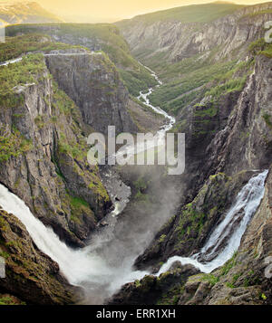 The big waterfall Voringsfossen with its 182 meter fall cascading into Mabodalen valley in Eidfjord, Hordaland, Norway at sunset Stock Photo
