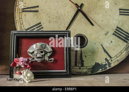 Picture frames skull and the clock on the old wooden Stock Photo