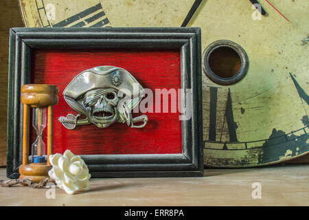 Picture frames skull and the clock on the old wooden background. Stock Photo