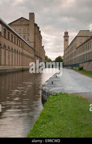Historic & impressive, Salts Mill, a former Victorian textile mill, stands by the towpath - banks of Leeds Liverpool canal, Saltaire, England, UK. Stock Photo
