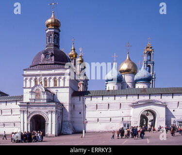 June 10, 1989 - Sergiyev Posad, Moscow Oblast, Russia - The Holy Gate, the main gate to the ancient Trinity Monastery of St. Sergius, and the Assumption Gate. Behind it are the towers of the Gateway Church of St John the Baptist, the onion domes of the Dormition (Cathedral of the Assumption) and the Bell Tower. The Trinity Lavra (monastery) of St. Sergius is the most important Russian monastery-fortress and the spiritual center of the Russian Orthodox Church. Founded in the 14th century by St Sergius of Radonezh, one of the Church's most highly venerated saints, it is 70 km (44 mi.) north-east Stock Photo