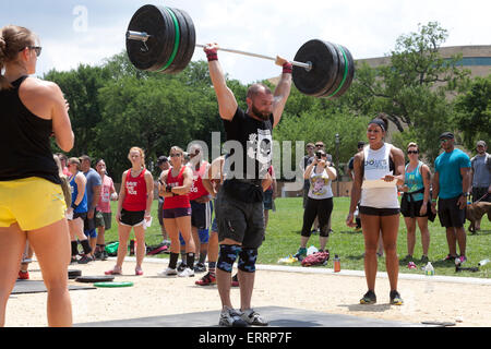 Man performing weightlifting at an outdoor fitness program - USA Stock Photo