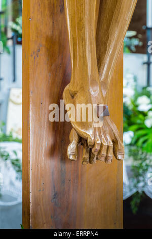 the detail of nailed feet in a wood carved statue  of the Crucifixion of Jesus Christ Stock Photo