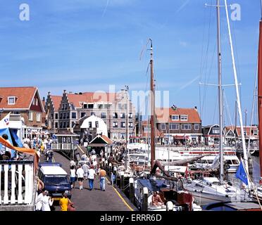 Tourists walking along the quayside shopping street during the Summertime, Volendam, Holland, Netherlands, Europe. Stock Photo