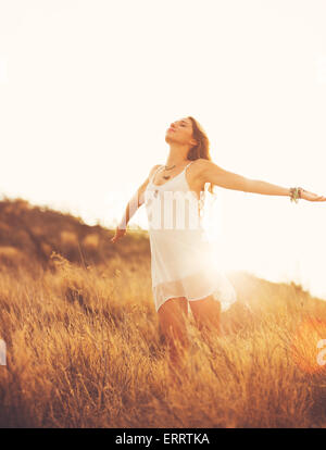 Happy Carefree Young Woman Outdoors. Fashion Lifestyle Portrait. Soft warm sunny colors. Stock Photo