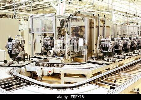 Production line for manufacturing of the engines in the car factory. Stock Photo