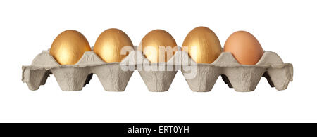 Four golden and one chicken eggs on a tray isolated on white background Stock Photo
