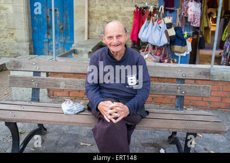 man sitting on a bench in Fontaine-de-Vaucluse, France Stock Photo