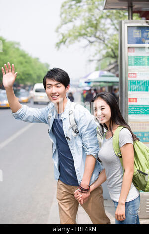 Young couple waiting at the bus stop Stock Photo