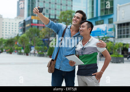 Two men tourists taking selfie photo smile, asian mix race Stock Photo
