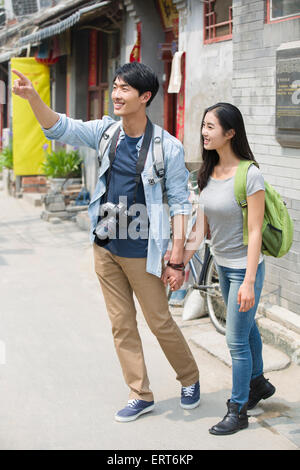 Young couple travelling in Beijing Hutong with camera Stock Photo