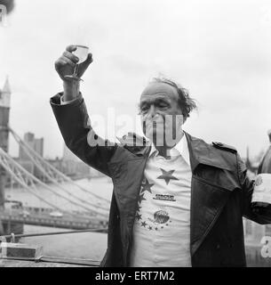 Karl Wallenda, Tightrope Walker, crosses 100ft above the ground, near Tower Bridge, London, Monday 22nd November 1976. Pictured celebrating after crossing. Stock Photo