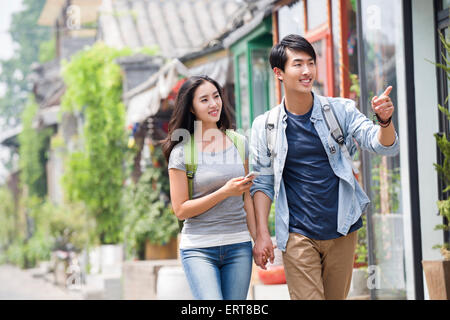 Young couple travelling in Beijing Hutong with smart phone Stock Photo