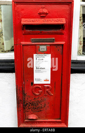 Weathered iconic red letterbox attached on the facade of the Old Post Office in Dorchester-on-Thames, Oxfordshire, England, UK. Stock Photo