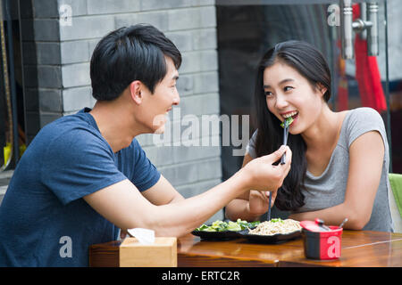 Happy young couple having lunch Stock Photo