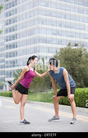 Young couple doing exercise outside Stock Photo