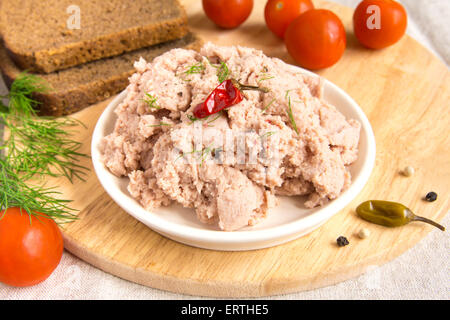 Liver pate with spices on wooden board Stock Photo