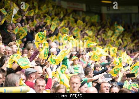 Norwich City Football fans wave flags during their Semi final second leg with Ipswich Town at Carrow road in Norwich